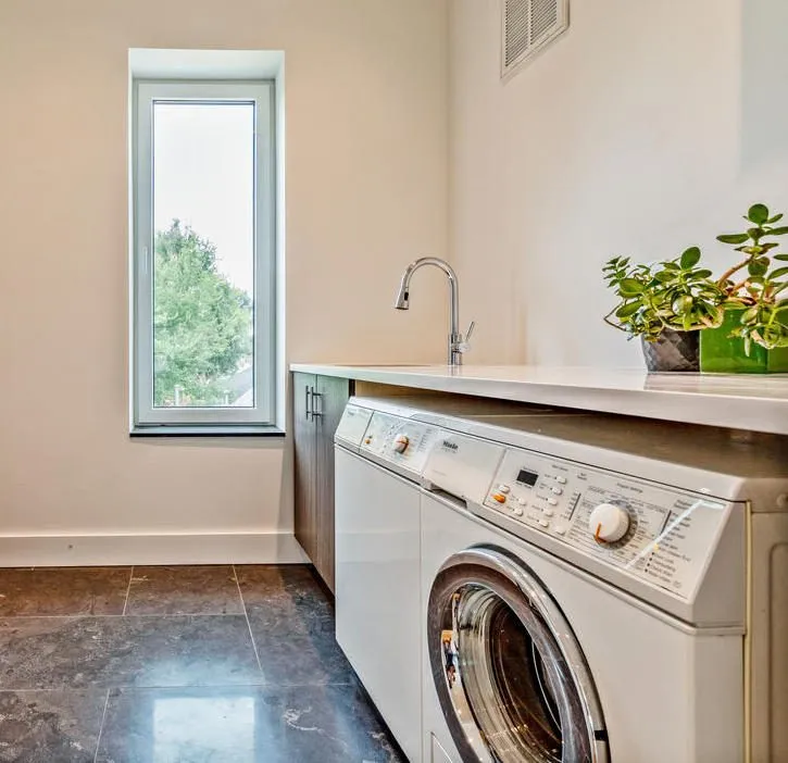 Laundry room with custom cabinetry and counter
