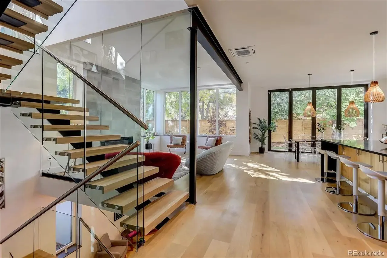 Open-riser stair with glass guardrail in a custom home built by Palo Alto Construction Management