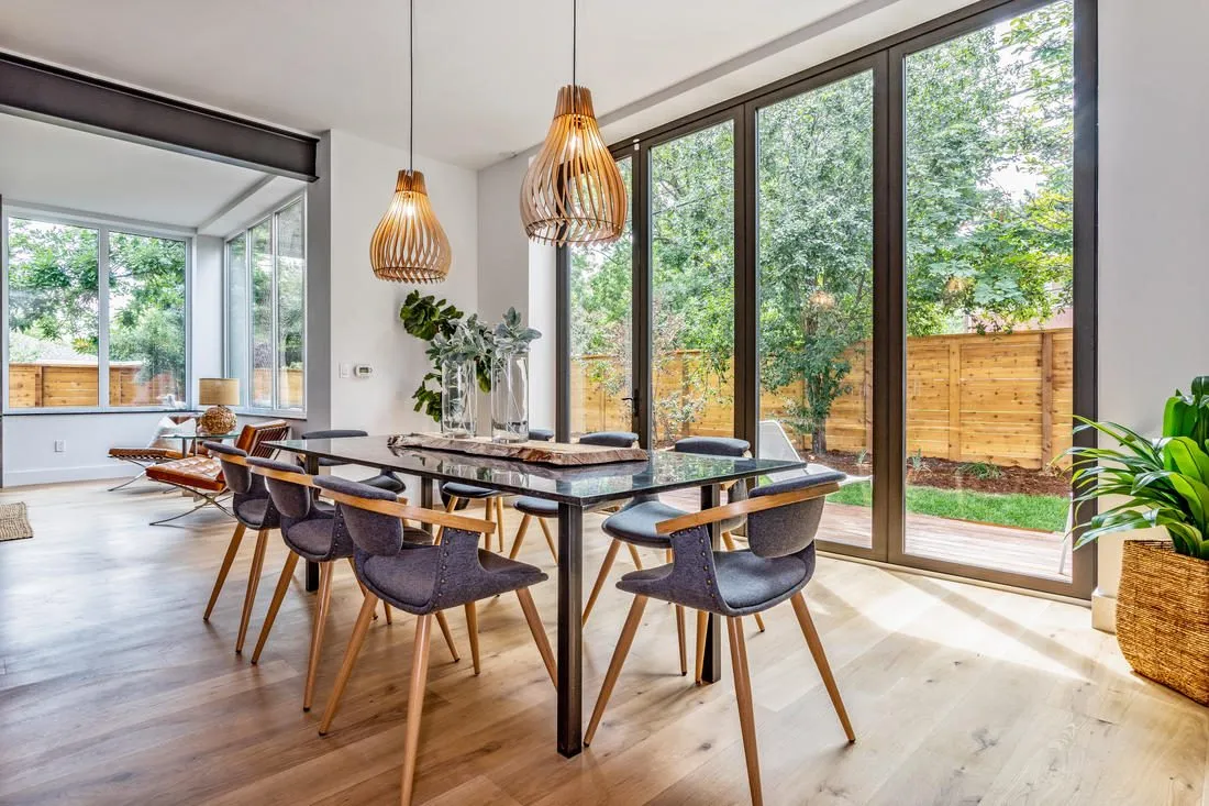 Stone-top dining table in a bright dining room